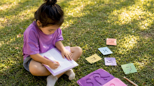 Child tracing heritage language letters at table