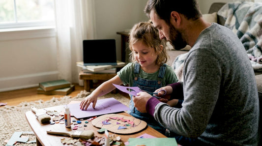 Young child drawing with crayons at preschool table